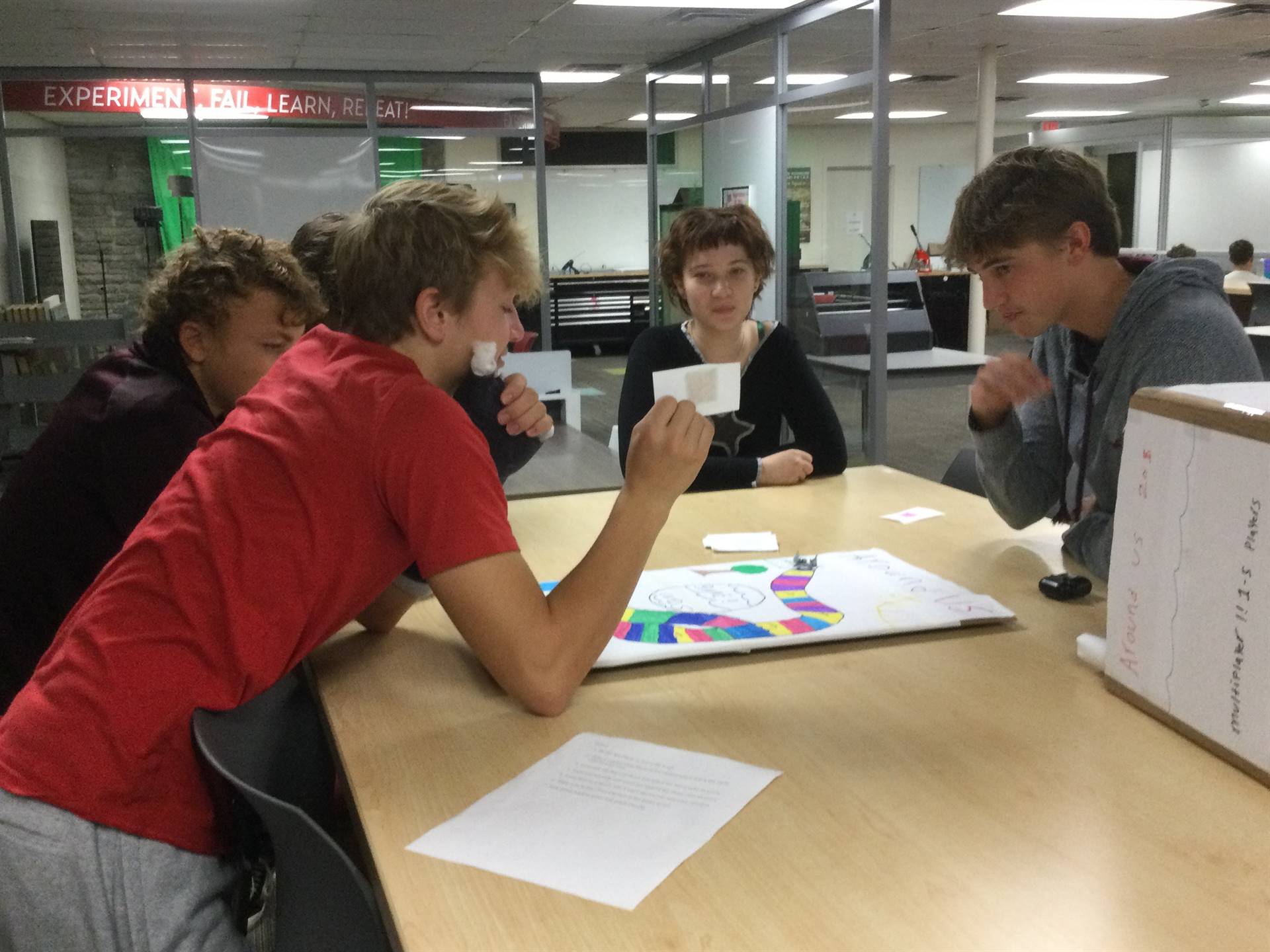 Students paying a board game of their own creation