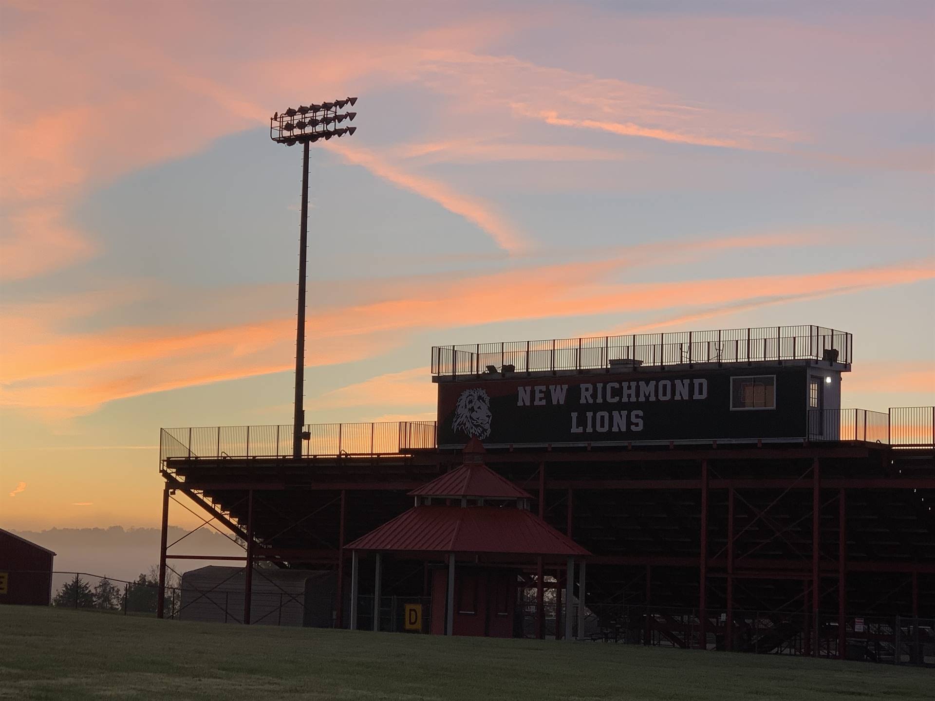 NRHS stadium at sunrise with what appears to be R written in the sky above