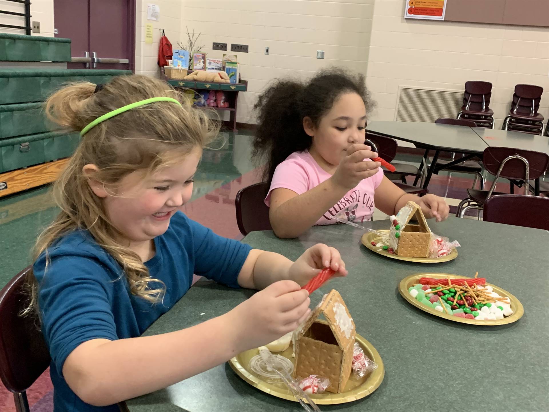two girls Gingerbread house making