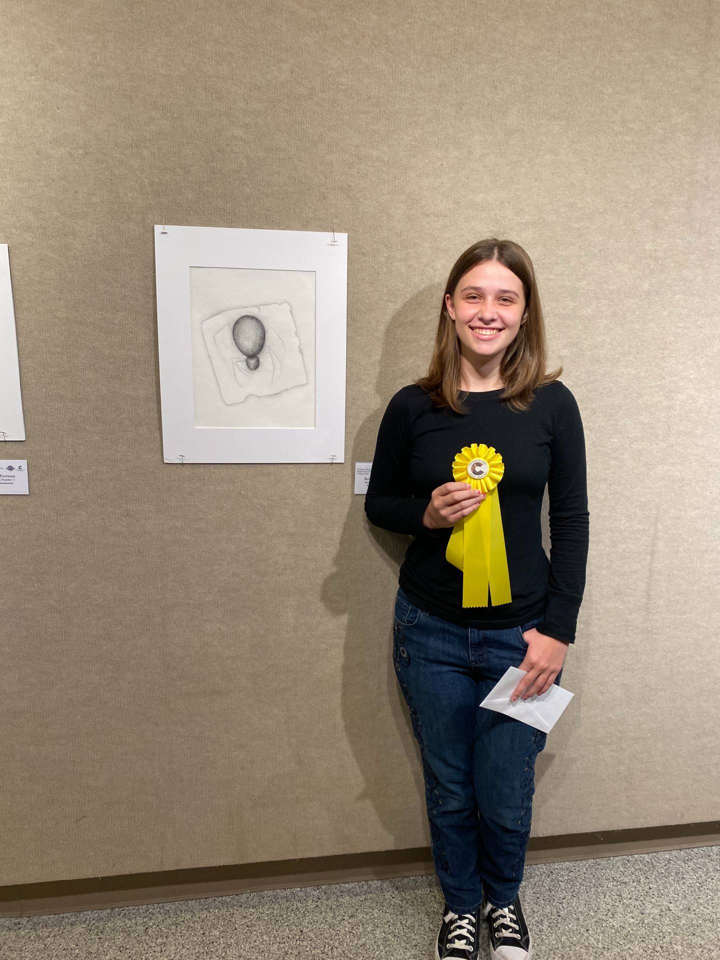 Art Award Winner with her ribbon and artwork