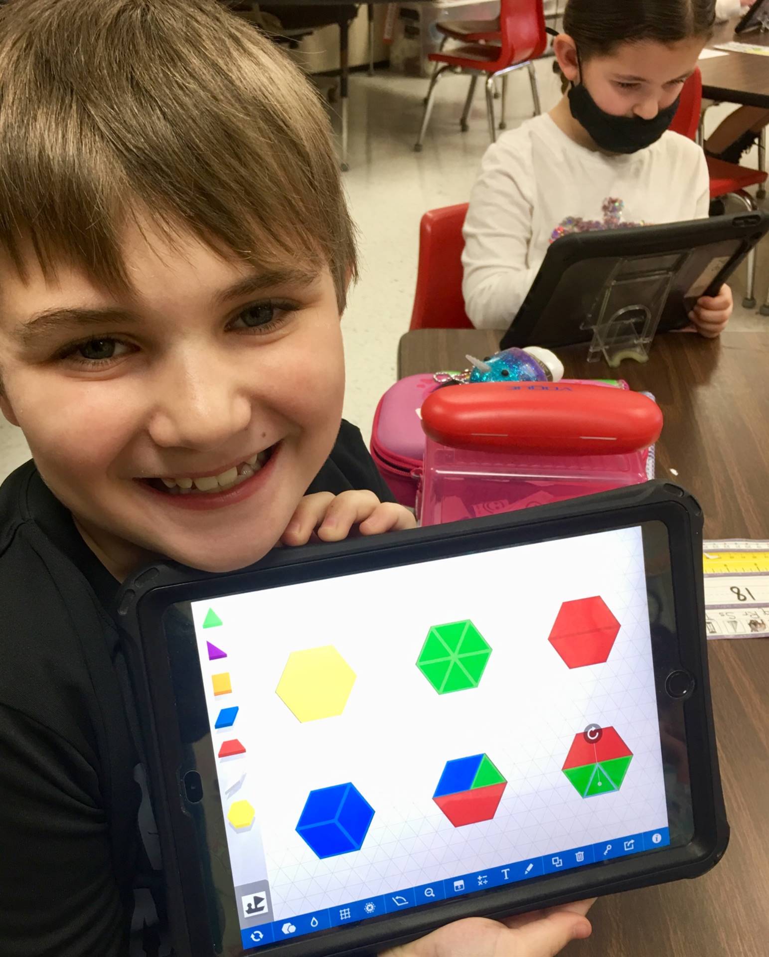 Student makes shapes with tablet