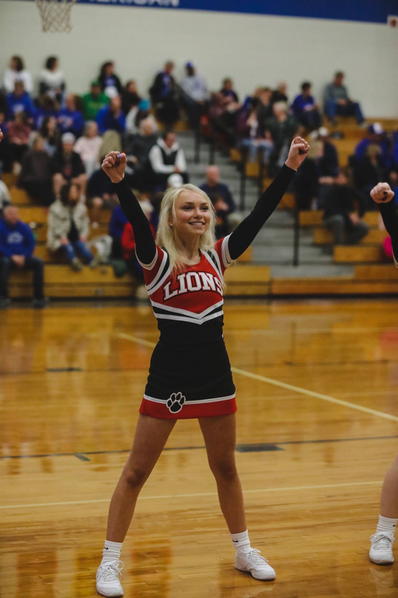 cheerleader with arms in air