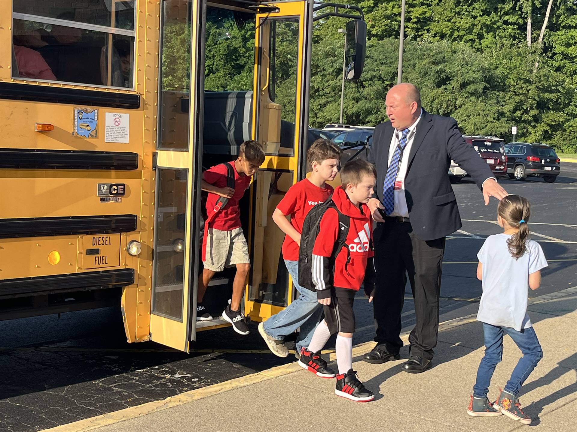 Mr Roach helping students off of the bus