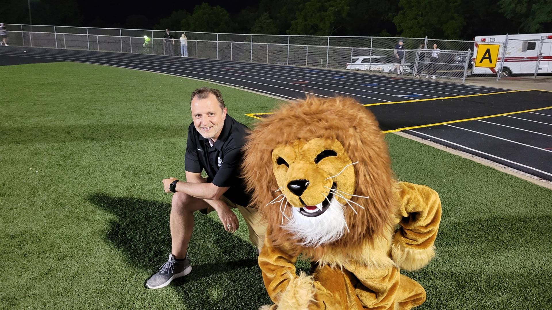 High school principal with the lion mascot